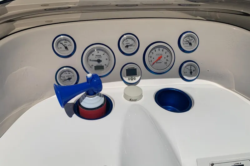 Slide: The Image of Dashboard of a 2006 Conquest 28 Top Cat II boat with gauges and controls. - 7