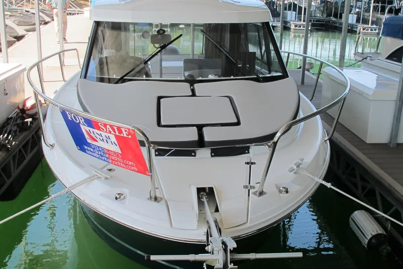 Slide: The Image of 2020 Jeanneau NC 795 boat for sale, docked with visible "For Sale" sign. - 1