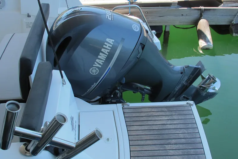 Slide: The Image of Yamaha outboard motor on 2020 Jeanneau NC 795 boat, docked in green water. - 13