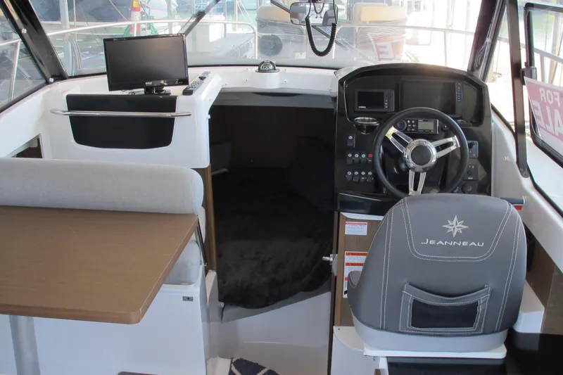 Slide: The Image of Interior of 2020 Jeanneau NC 795 boat with helm, seating, and navigation equipment. - 14