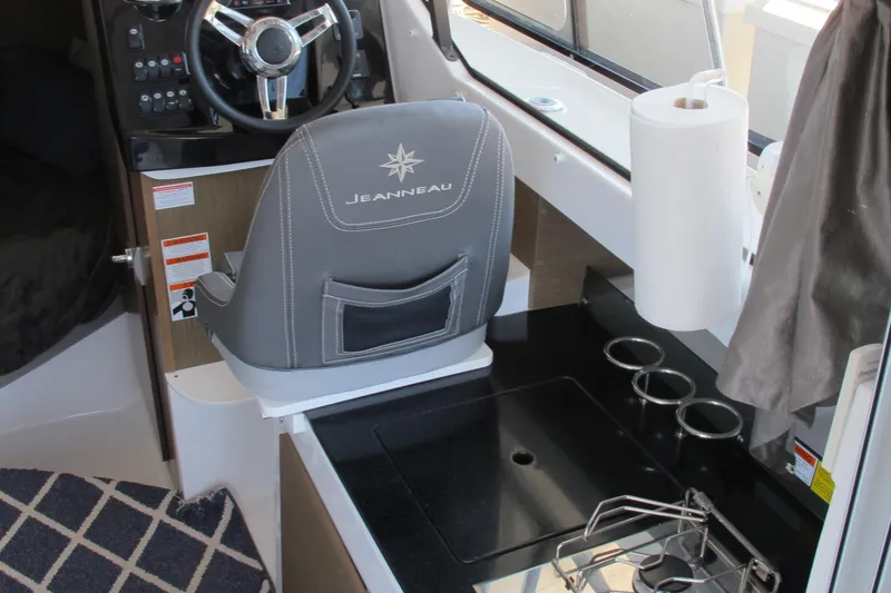 Slide: The Image of Interior of 2020 Jeanneau NC 795 boat with helm seat and kitchenette area. - 16