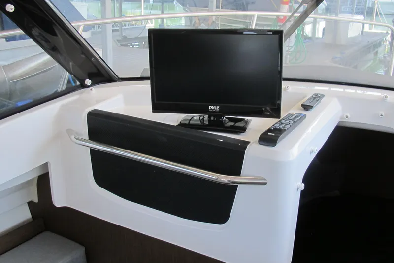 Slide: The Image of Interior of 2020 Jeanneau NC 795 boat with mounted Pyle monitor and remote controls. - 18