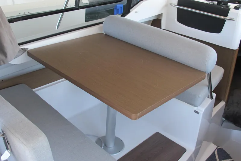 Slide: The Image of Interior of 2020 Jeanneau NC 795 boat with dining table and seating area. - 19