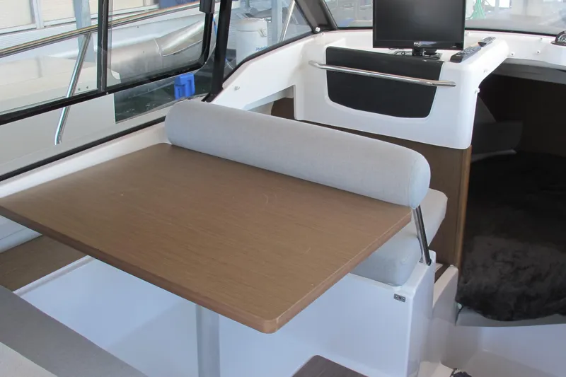 Slide: The Image of Interior of 2020 Jeanneau NC 795 boat with dining table and seating area. - 21