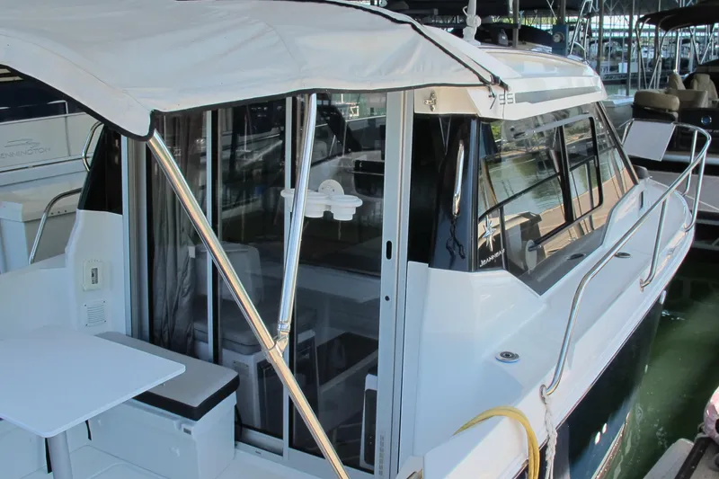 Slide: The Image of 2020 Jeanneau NC 795 boat with canopy and seating area in marina. - 5
