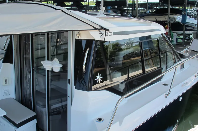 Slide: The Image of 2020 Jeanneau NC 795 boat docked, showcasing sleek design and modern features. - 6