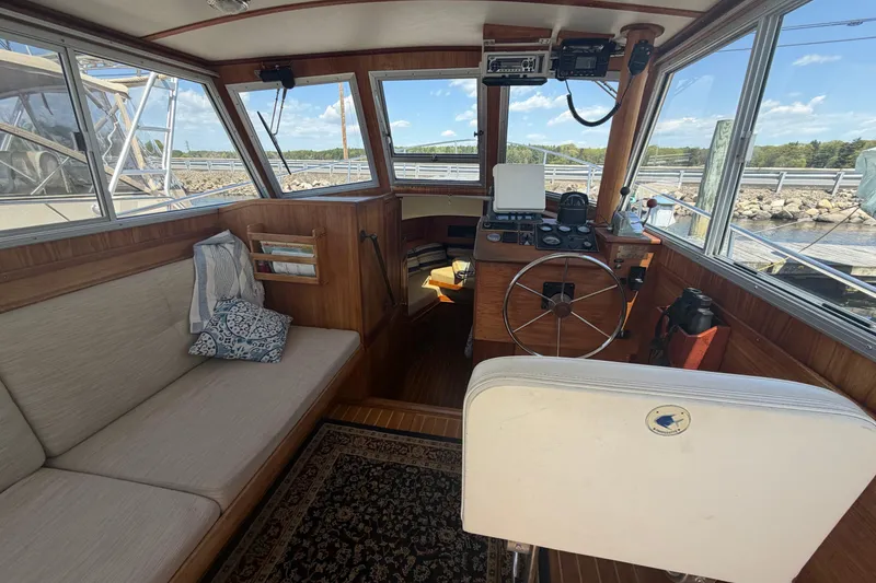 Slide: The Image of Interior of a 1990 Cape Dory 28 Flybridge boat with helm and seating area. - 15