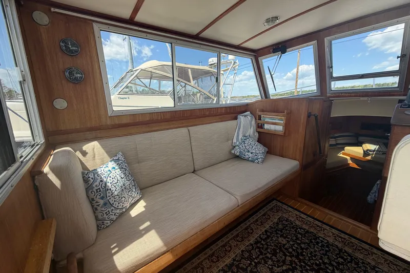 Slide: The Image of Interior of a 1990 Cape Dory 28 Flybridge boat with cozy seating and nautical decor. - 2