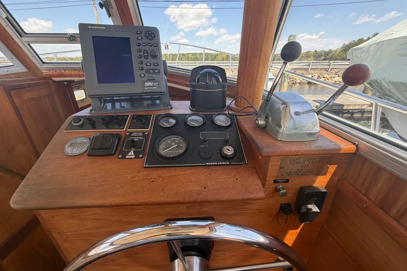 Slide: The Image of Helm of 1990 Cape Dory 28 Flybridge with navigation equipment and controls. - 9
