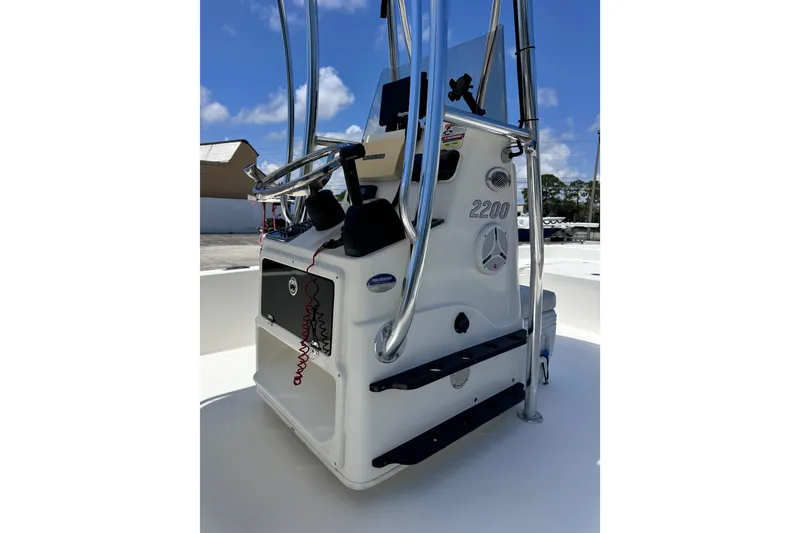 Slide: The Image of 2012 Pathfinder 2200 TRS boat console with steering wheel and controls. - 13