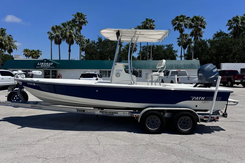 Slide: The Image of 2012 Pathfinder 2200 TRS boat on trailer, parked outside marine service shop. - 5