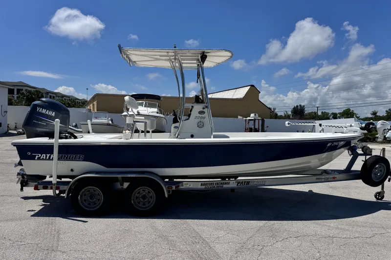 Slide: The Image of 2012 Pathfinder 2200 TRS boat on trailer with Yamaha motor, parked outdoors. - 9