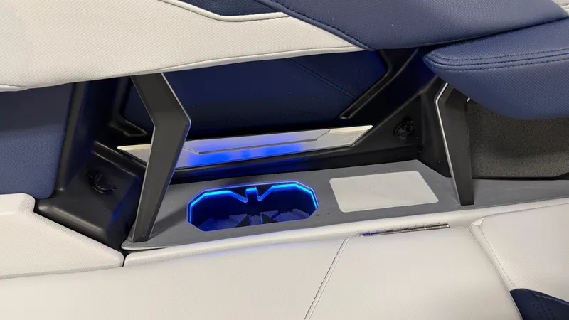 Slide: The Image of Close-up of a MasterCraft XT23 boat seat with blue LED lighting and a cup holder. - 28