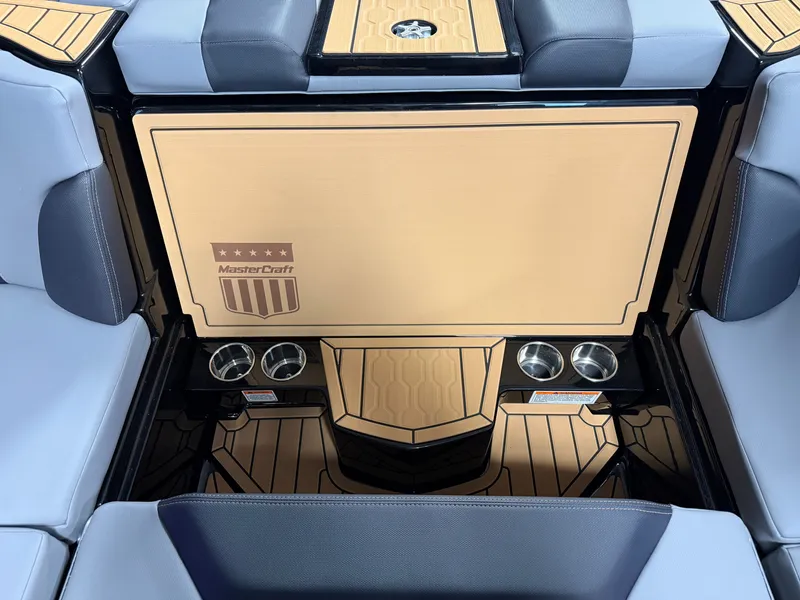Slide: The Image of The image shows the interior of a MasterCraft XT23 boat with sleek seating and cup holders. - 38