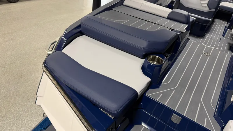 Slide: The Image of The image shows the stern of a MasterCraft XT23 boat with blue upholstery and gray flooring. - 10