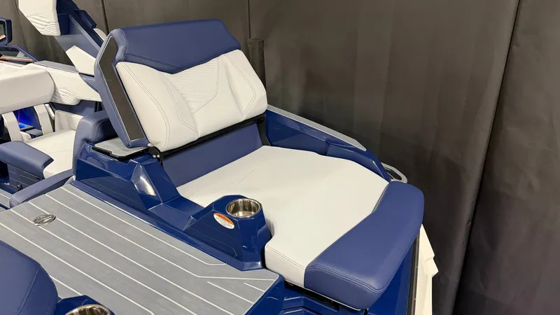 Slide: The Image of The image shows the seating area of a MasterCraft XT23 boat with blue and white upholstery. - 16