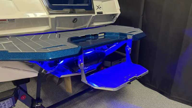 Slide: The Image of The image shows the stern of a 2027 MasterCraft XT23 with a blue swim platform. - 8