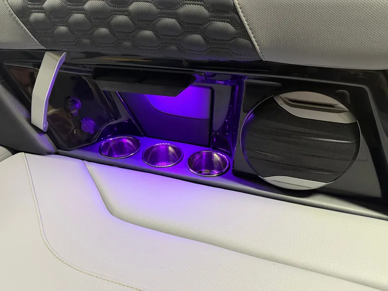 Slide: The Image of The 2027 MasterCraft XT23 interior features illuminated cup holders and a modern speaker system. - 43