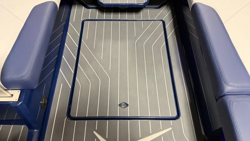 Slide: The Image of The image shows the floor of a MasterCraft XT23 boat with blue upholstery. - 45