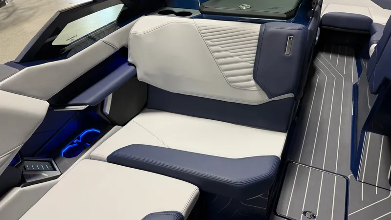 Slide: The Image of The image shows the luxurious interior of a MasterCraft XT23 boat with modern blue and white seating. - 49