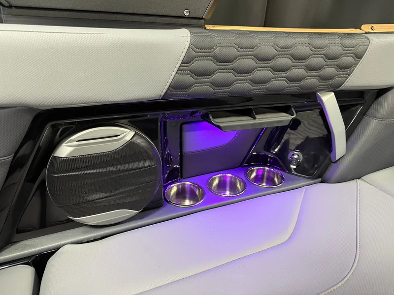 Slide: The Image of The 2027 MasterCraft XT23 interior features speakers, cup holders, and ambient lighting. - 32