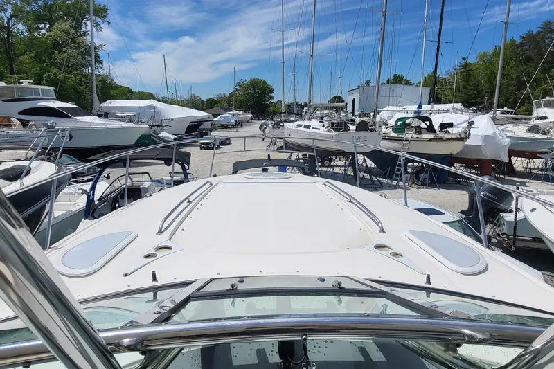Slide: The Image of 2008 Monterey 350 Sport Yacht docked among other boats under a clear blue sky. - 12