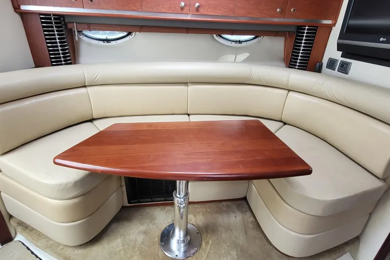 Slide: The Image of 2008 Monterey 350 Sport Yacht interior with beige seating and wooden table. - 18