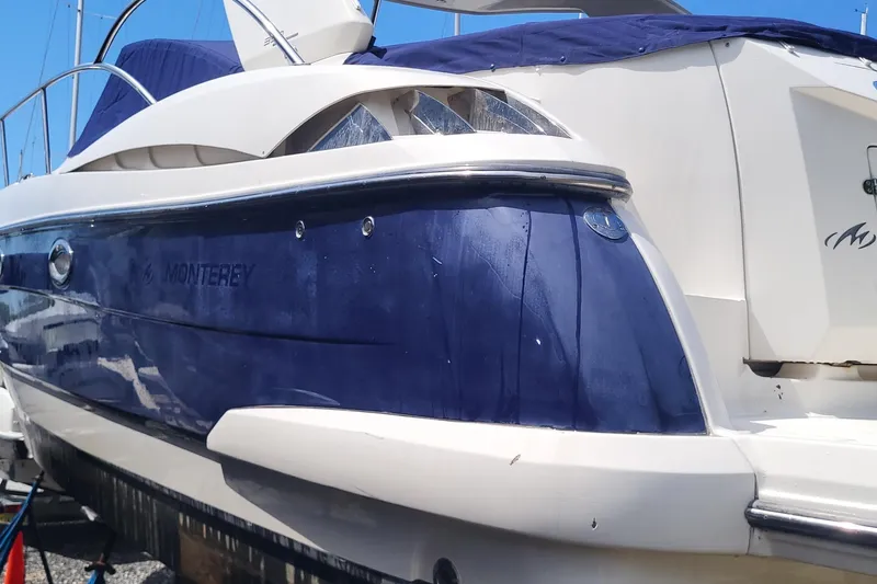 Slide: The Image of 2008 Monterey 350 Sport Yacht with blue and white exterior, docked under clear sky. - 2