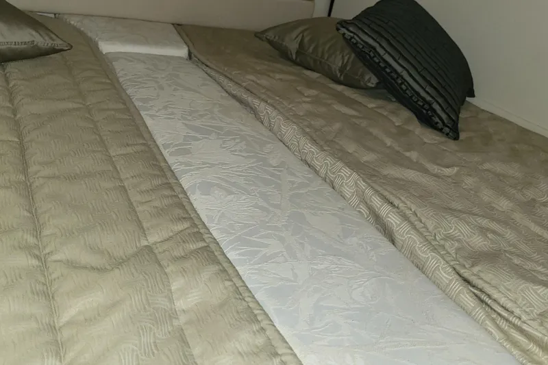 Slide: The Image of Interior cabin bed with beige bedding on a 2008 Monterey 350 Sport Yacht. - 22