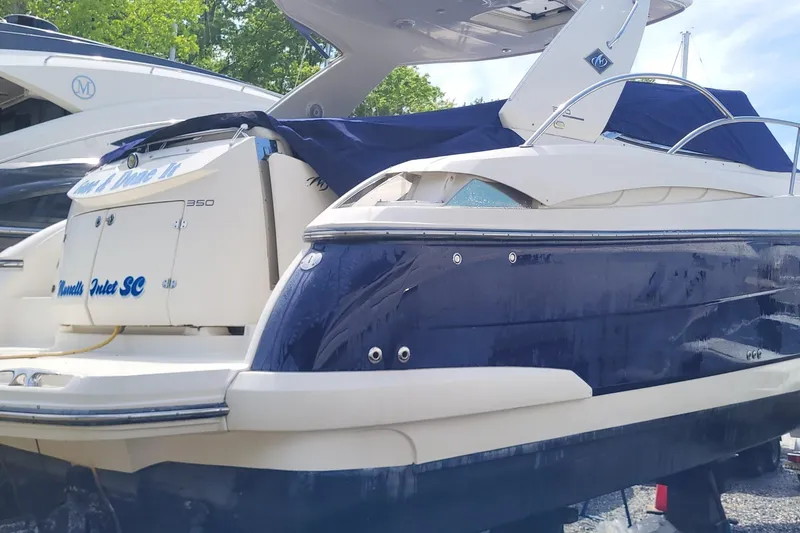 Slide: The Image of 2008 Monterey 350 Sport Yacht with blue and white exterior, docked outdoors. - 23