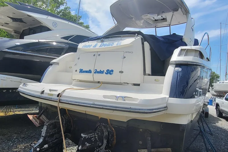 Slide: The Image of 2008 Monterey 350 Sport Yacht docked, rear view, with other boats in the background. - 24