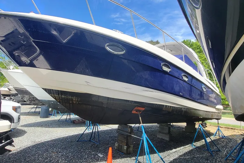 Slide: The Image of 2008 Monterey 350 Sport Yacht on stands, blue hull, sunny day. - 3