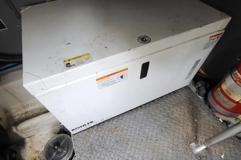 Slide: The Image of Kohler power system in 2008 Monterey 350 Sport Yacht engine room, with fire extinguisher nearby. - 6