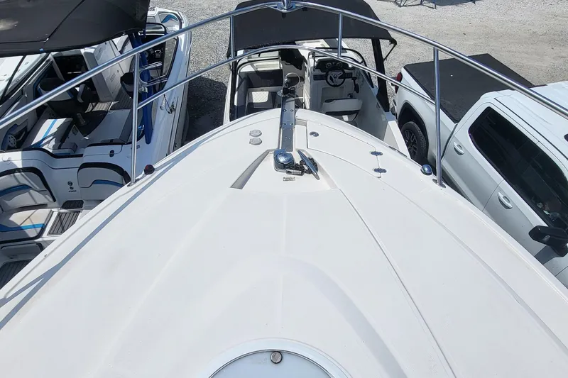 Slide: The Image of 2008 Monterey 350 Sport Yacht docked, view from bow, surrounded by other boats and vehicles. - 8