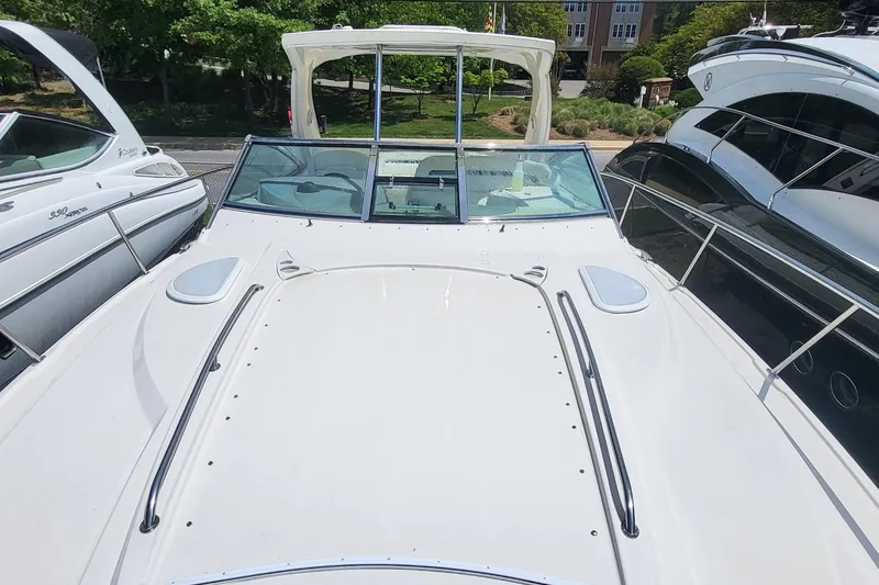 Slide: The Image of 2008 Monterey 350 Sport Yacht, white deck view, docked between two boats. - 9