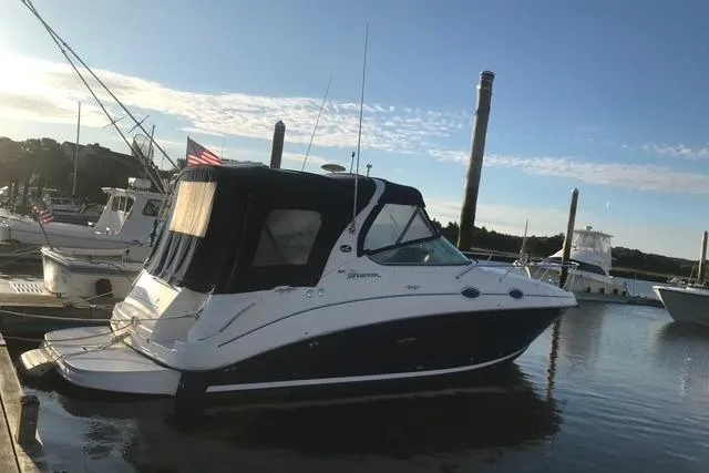The Image of 2004 Sea Ray Sundancer 280 docked at marina under clear sky. - 0