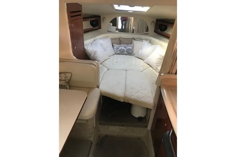 Slide: The Image of Interior cabin of 2004 Sea Ray Sundancer 280 with cozy bedding and pillows. - 12
