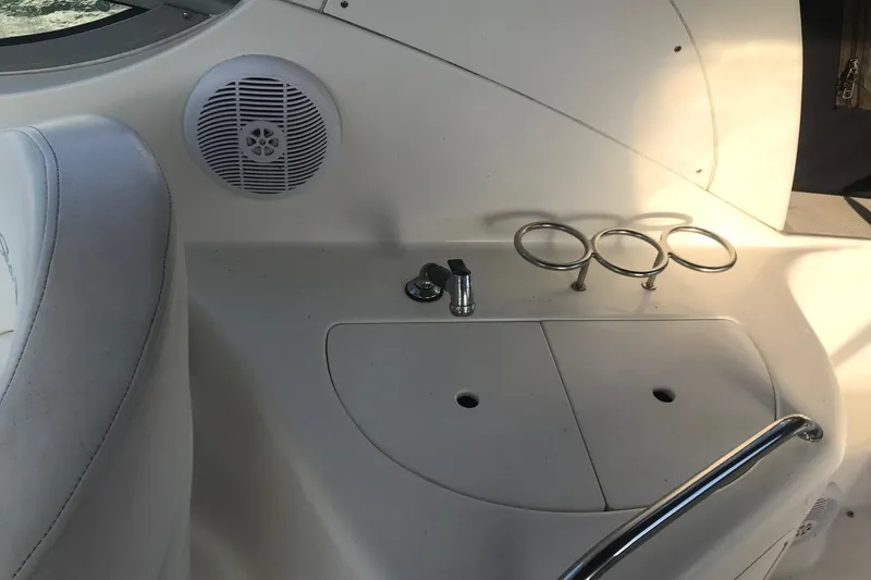 Slide: The Image of Interior of 2004 Sea Ray Sundancer 280 boat with speaker and cup holders. - 13