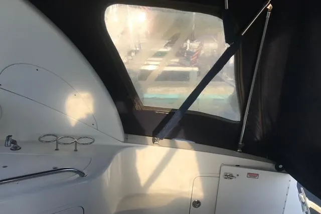 Slide: The Image of 2004 Sea Ray Sundancer 280 interior with covered cockpit and window view. - 14