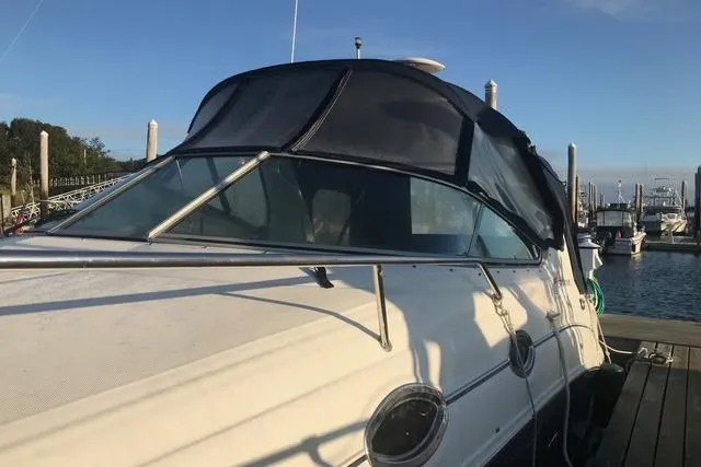 Slide: The Image of 2004 Sea Ray Sundancer 280 docked at a marina under clear blue skies. - 4