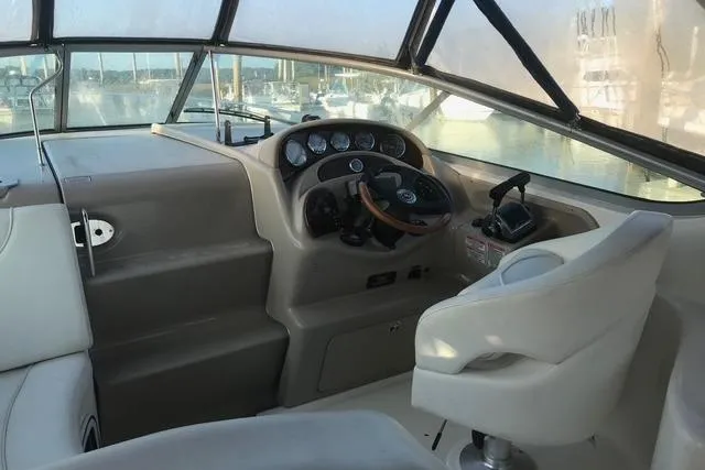 Slide: The Image of 2004 Sea Ray Sundancer 280 helm with steering wheel and control panel. - 6