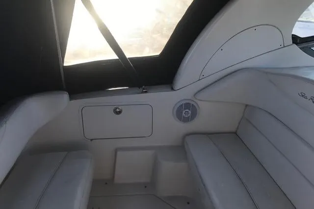 Slide: The Image of Interior of a 2004 Sea Ray Sundancer 280 boat, featuring cushioned seating and a speaker. - 7