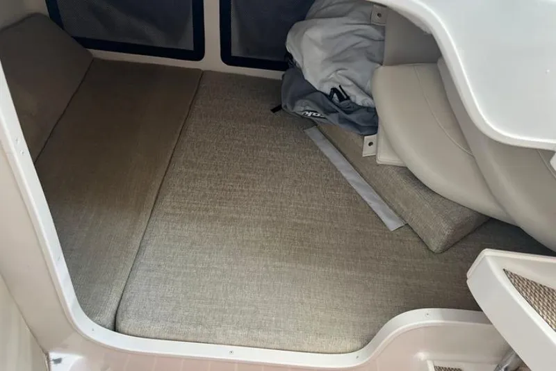Slide: The Image of Interior cabin of a 2017 Grady-White Marlin 300 boat with beige cushions. - 15