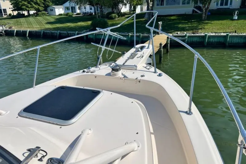 Slide: The Image of 2017 Grady-White Marlin 300 boat docked by a waterfront property. - 16