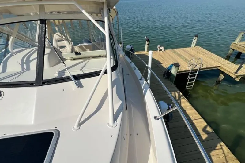 Slide: The Image of 2017 Grady-White Marlin 300 boat docked by wooden pier on calm water. - 18