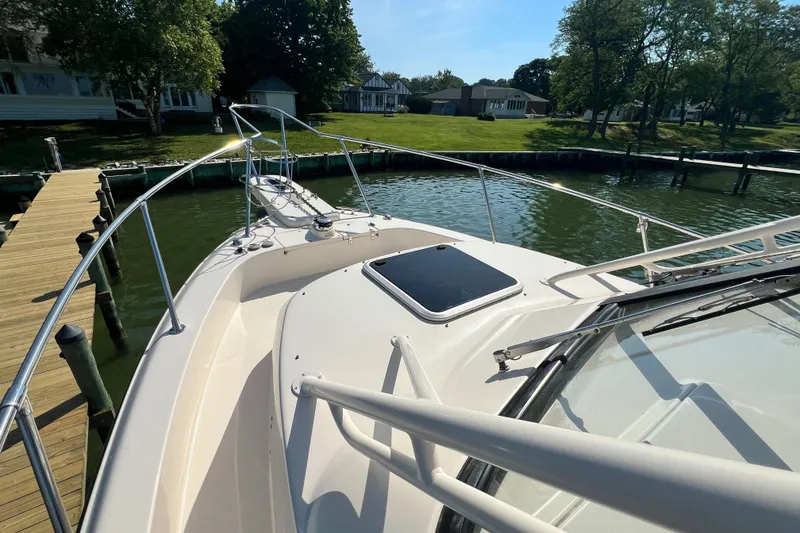 Slide: The Image of 2017 Grady-White Marlin 300 boat docked by a scenic waterfront. - 19