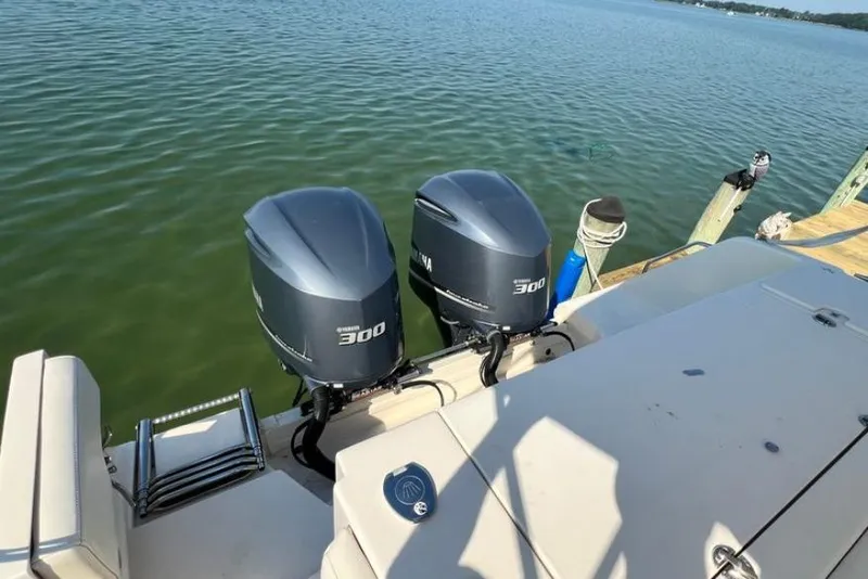 Slide: The Image of 2017 Grady-White Marlin 300 boat with twin Yamaha 300 engines on calm water. - 20