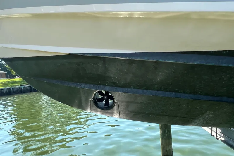 Slide: The Image of 2017 Grady-White Marlin 300 boat hull with bow thruster, docked on calm water. - 30
