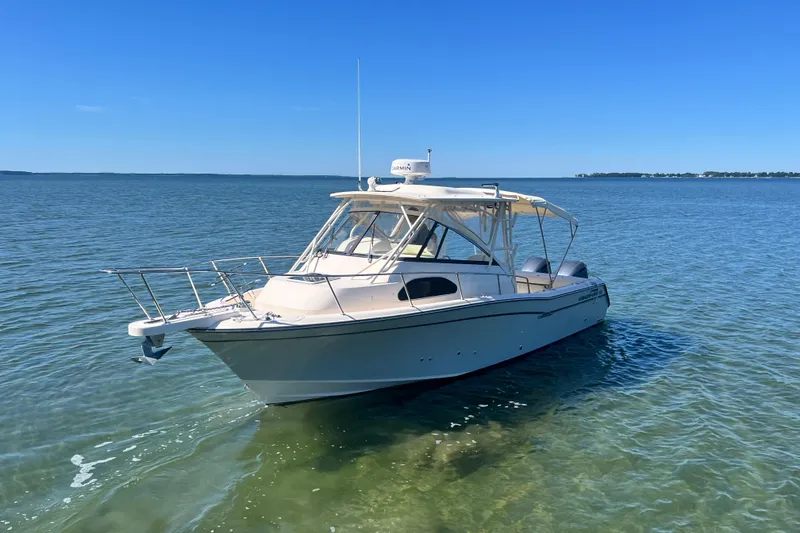 Slide: The Image of 2017 Grady-White Marlin 300 boat on clear blue water under sunny sky. - 36