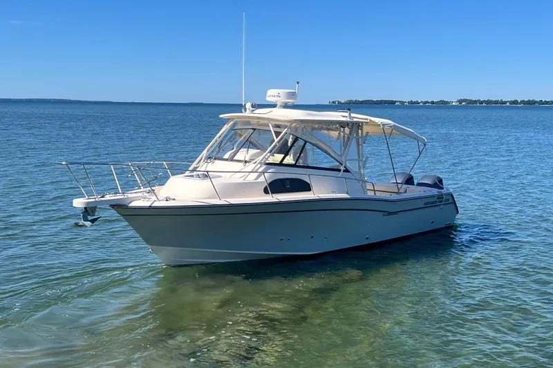 Slide: The Image of 2017 Grady-White Marlin 300 boat on clear blue water under sunny sky. - 37